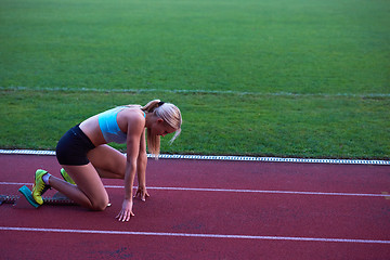 Image showing pixelated design of woman  sprinter leaving starting blocks