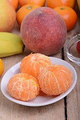 Image showing Fresh colorful fruits composition mandarin, strawberry, peach, bananas and orange