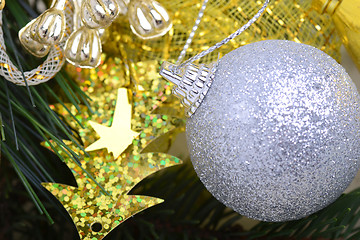 Image showing festive golden christmas decoration, candles, white balls, green fir tree branch, close up