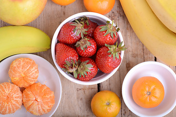 Image showing Fresh colorful fruits composition mandarin, strawberry, peach, bananas and orange