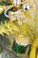 Image showing Christmas background with drums, green eve tree branch, golden new year decoration 