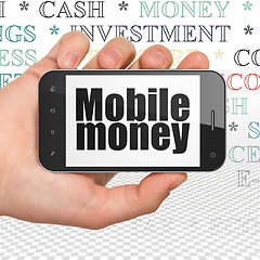 Image showing Money concept: Hand Holding Smartphone with Mobile Money on display