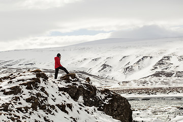 Image showing Hiker at mountain top of waterfall Godafoss