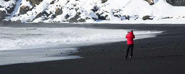 Image showing Photographer at the black sand beach in Vik, Iceland