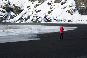Image showing Photographer at the black sand beach in Vik, Iceland
