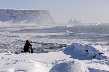 Image showing Woman enjoys view o three pinnacles of Vik, Iceland