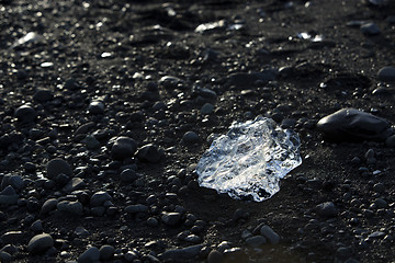 Image showing Ice block on black sand beach at glacier lagoon Jokulsarlon, Ice