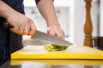 Image showing Chef chopping greens