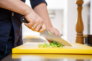 Image showing Chef chopping greens