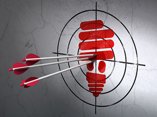 Image showing Business concept: arrows in Energy Saving Lamp target on wall background