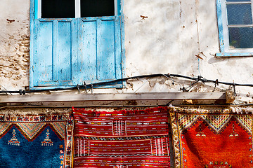 Image showing blue window in morocco  wall red carpet