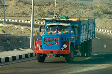 Image showing Old truck with arabian people on road of Egypt