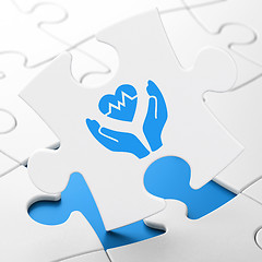 Image showing Insurance concept: Heart And Palm on puzzle background