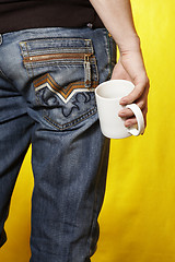 Image showing a young caucasian man with white tea cup