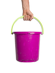 Image showing Human hand holding empty plastic pail