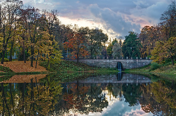 Image showing Autumn lake with stone bridge at evening