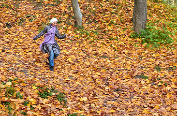 Image showing girl run in bright yellow autumn forest