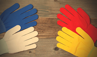 Image showing four new working multicolored gloves