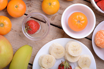 Image showing Fresh colorful fruits composition mandarin, strawberry, peach, bananas and orange