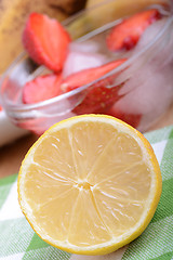 Image showing Close up of a cup of sliced strawberries with lemon