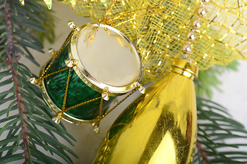 Image showing Christmas background with drums, green eve tree branch, golden new year decoration 