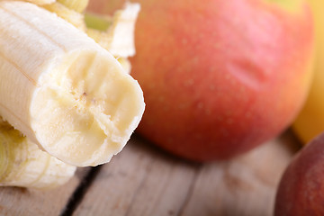 Image showing Mandarin Apples and Bananas on wooden plate