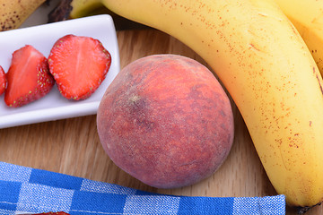 Image showing peach strawberry bananas mandarin close up as health food concept