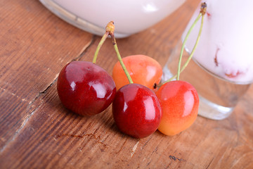 Image showing a delicious cherry milkshake on wooden plate