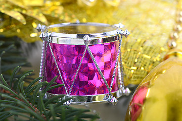 Image showing Christmas background with drums, green eve tree branch, golden new year decoration 