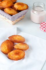 Image showing Madeleine small traditional French desserts with strawberries