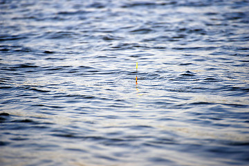 Image showing Fishing background: float bobs on the waves.