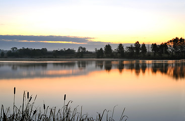 Image showing The morning landscape with sunrise over water in the fog