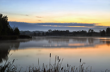 Image showing The morning landscape with sunrise over water in the fog