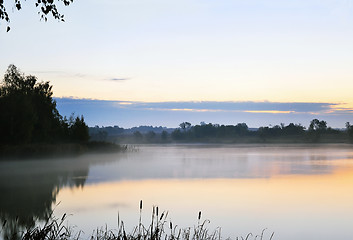 Image showing The morning landscape with sunrise over water in the fog