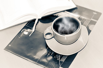 Image showing Cup of coffee on the desk in the office