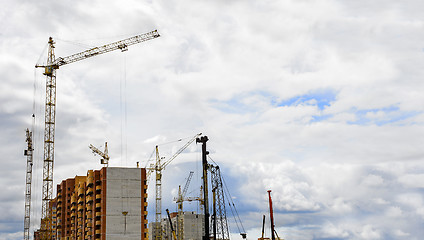 Image showing Cranes and building construction on the background of clouds