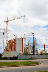 Image showing Cranes and building construction on the background of clouds