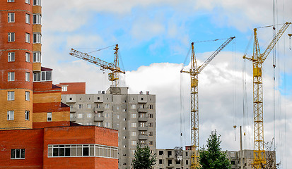 Image showing Cranes and building construction on the background of clouds