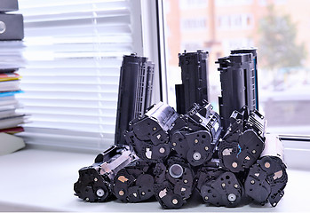 Image showing Cartridges from the printer stacked on the windowsill Office