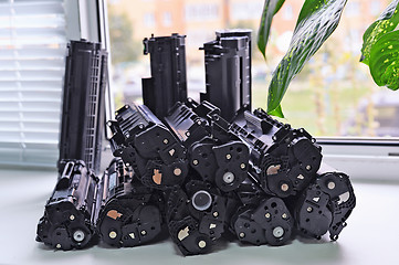 Image showing Cartridges from the printer stacked on the windowsill Office