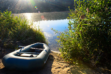 Image showing Fishing boat on the river in the rays of dawn