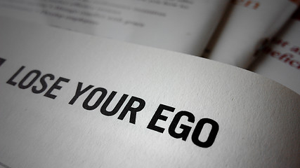 Image showing Lose your ego word on a book