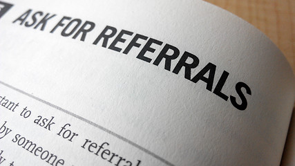 Image showing Ask for referrals word on a book