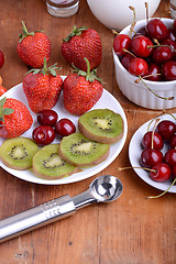 Image showing fruit with cherry, strawberry, kiwi on wooden plate