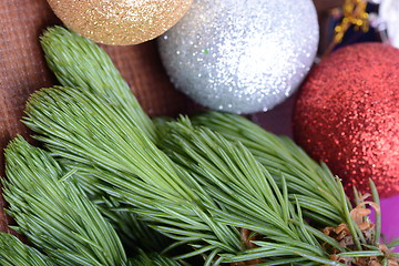 Image showing Closeup of beautiful Christmas baubles, Decorated christmas tree, holiday background, green tree eve branch close up with christmas balls 