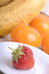 Image showing Fresh colorful fruits composition mandarin, strawberry, peach, bananas and orange