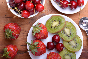 Image showing fruit with cherry, strawberry, kiwi on wooden plate