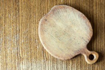 Image showing old wooden apple shape cutting board on the table