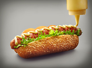 Image showing Hot dog with pouring mayonnaise