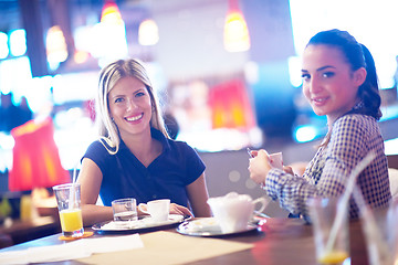 Image showing girls have cup of coffee in restaurant